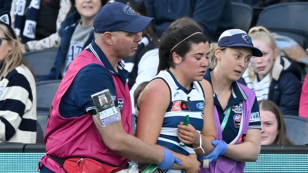 Rachel Kearns is helped off the field during Geelong Cats' clash with Richmond Tigers
