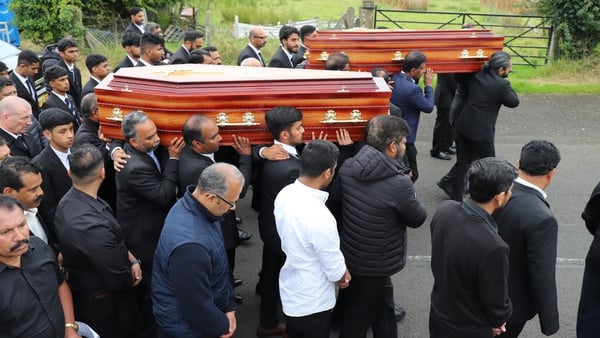 The coffins of Reuven Simon and Joseph Sebastian leave St Mary's Church in Ardmore, Co Derry