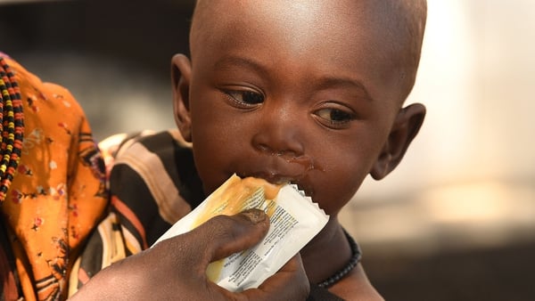 A mother feeds her son with nutrition supplements in a village in north Kenya