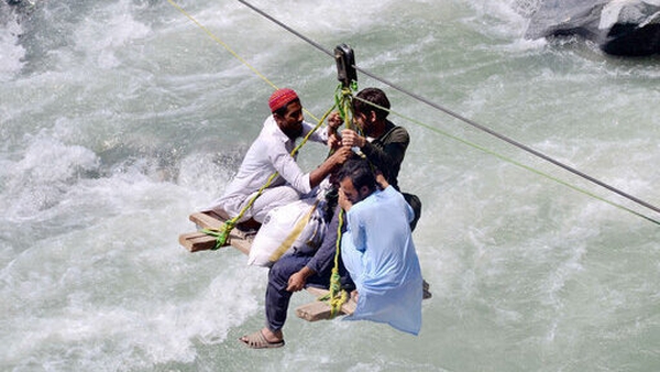 Residents cross the river Swat, in the Bahrain area of northwest Pakistan