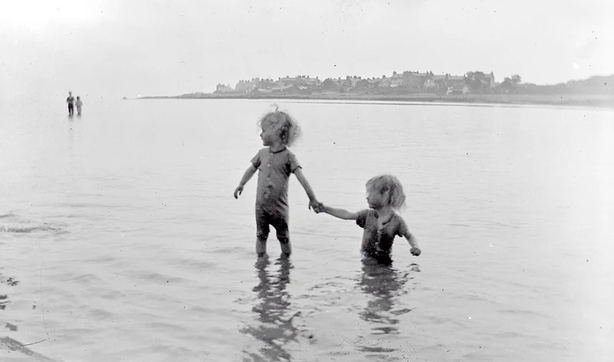 Summer swimming: two little children, George and Mary Mahon, bathing at the seaside. Photo: National Library of Ireland, CLON1319