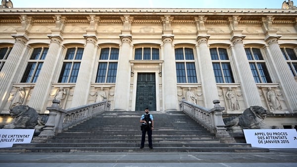 A guard stands outside the courthouse in Paris