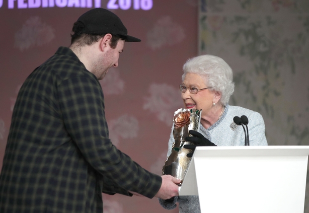 Queen Elizabeth II presenting Richard Quinn with the inaugural Queen Elizabeth II Award for British Design in 2018