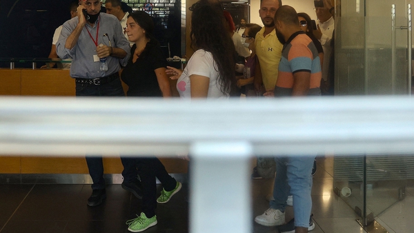 Sali Hafiz, wearing green shoes, is pictured inside the bank in Beirut
