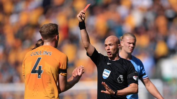 Referee Anthony Taylor shows the Ireland defender the straight red card