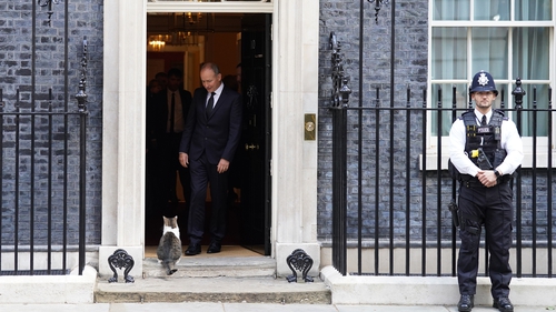 Micheál Martin looking at Larry the cat as he leaves 10 Downing Street in London this morning