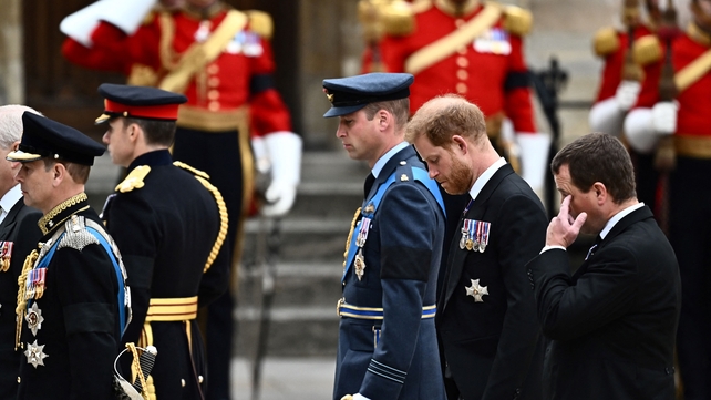 Princes William and Harry walk behind their grandmother's coffin in a procession through London (Marco Bertorello/AFP)