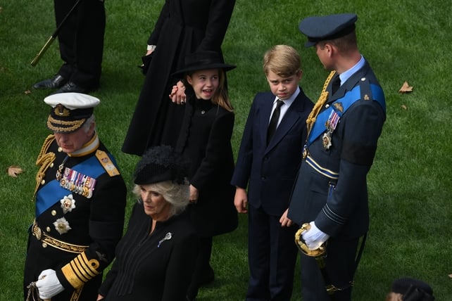 King Charles III and Queen Consort Camilla stand in front of Prince William and his children George and Charlotte (Daniel Leal/AFP)