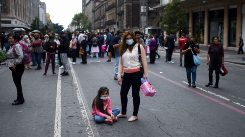 People evacuate buildings onto the streets in Mexico City after the earthquake hit