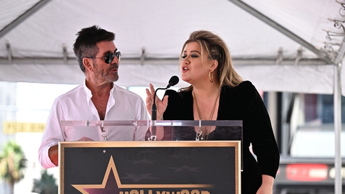 Simon Cowell speaks with Kelly Clarkson onstage during the Star Ceremony for Kelly Clarkson on the Hollywood Walk of Fame on September 19, 2022 in Los Angeles, California. (Photo by Michael Buckner/Variety via Getty Images)