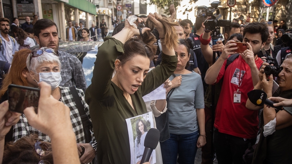 Protester cuts her hair outside Iran's consulate in Istanbul, Turkey