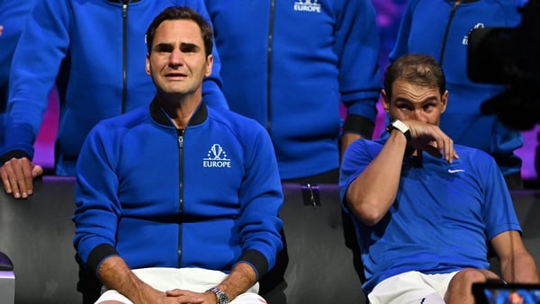 Roger Federer (L) sheds a tear after playing his final match, as does doubles partner in his final game, Spain's Rafael Nadal (R)