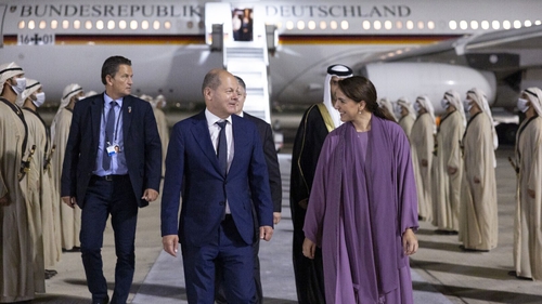 German Chancellor Olaf Scholz is welcomed by UAE Minister of Climate Change and Environment Mariam bint Mohammed Saeed Hareb Almheiri in Abu Dhabi, United Arab Emirates