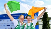 Sanita Puspure, left, and Zoe Hyde celebrate with their bronze medals