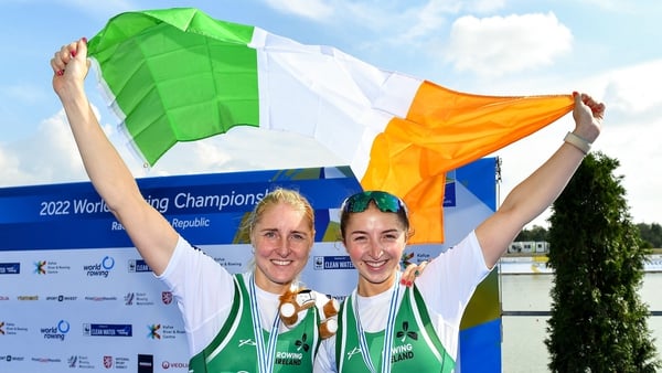 Sanita Puspure, left, and Zoe Hyde celebrate with their bronze medals