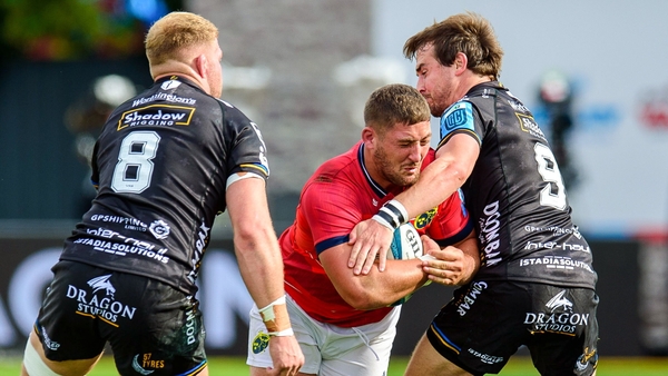 Dan Goggin of Munster is tackled by Ross Moriarty, left, and Rhodri Williams of Dragons during the United Rugby Championship match between Dragons and Munster at Rodney Parade in Newport,