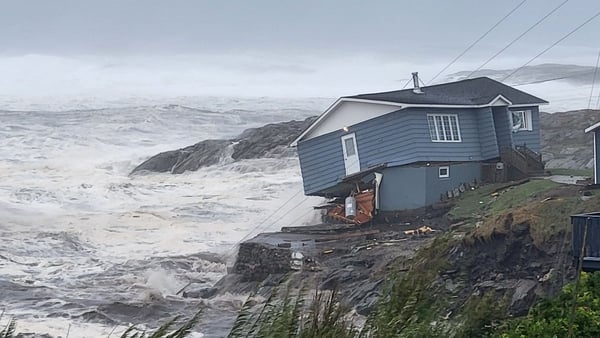 A damaged house is seen perched on the shore in Port aux Basques, Newfoundland, Canada