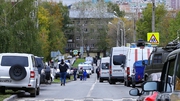 Police and members of emergency services work near the scene of a school shooting in Izhevsk