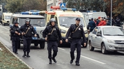 Policemen walk near the scene of a shooting in school No88 in Izhevsk, Russia