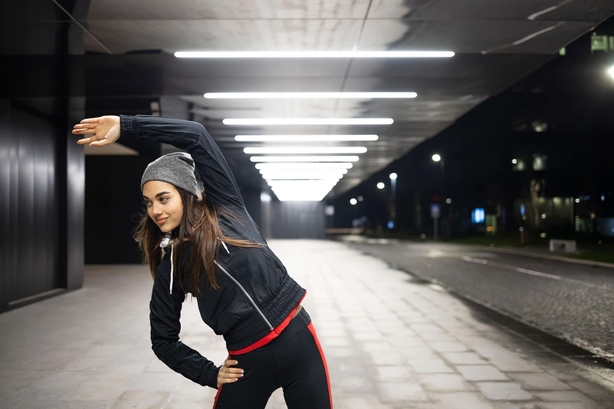 Woman stretching at night