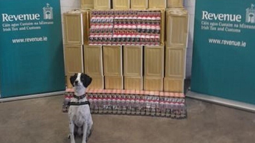 Detector dog Milo pictured with the cigarettes seized at Dublin Port