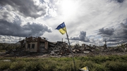 A Ukrainian flag in the heavily damaged village of Dolyna in Donetsk Oblast