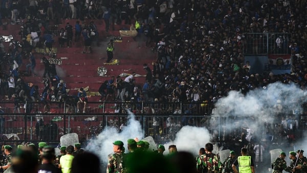 Police fired tear gas after Arema FC supporters stormed the pitch