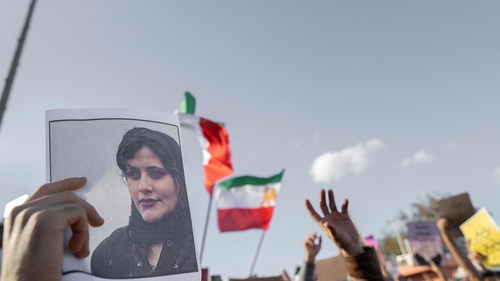 A protestors holds a photo of Kurdish Iranian woman Mahsa Amini during a demonstration against the Iranian regime