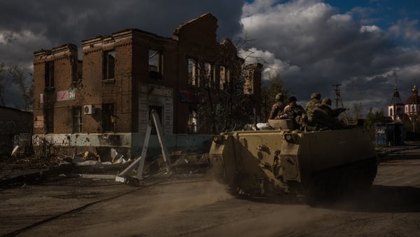 A Ukrainian armoured personnel carrier drives through the destroyed village of Shandryholove near Lyman