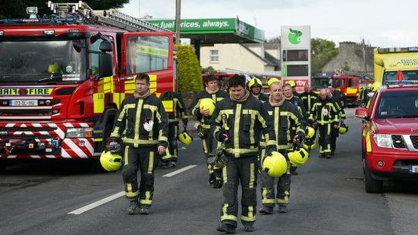 Firefighters leave the scene of an explosion at Applegreen service station in the village of Creeslough