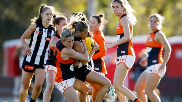 Collingwood's Sarah Rowe is tackled by Annalyse Lister of Greater Western Sydney