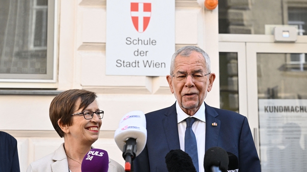 Austria's President Alexander Van der Bellen and his wife Doris speak to the media in front of a polling station in Vienna