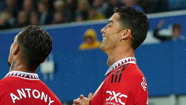 Cristiano Ronaldo celebrates scoring his 700th club goal with team-mate Antony