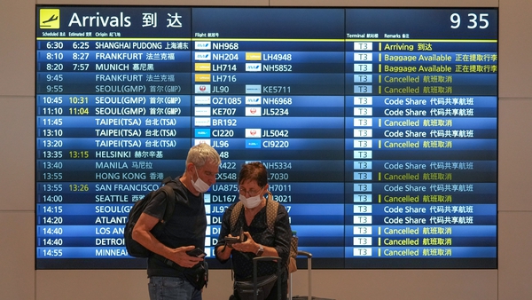 Passengers arrive at Haneda Airport in Tokyo