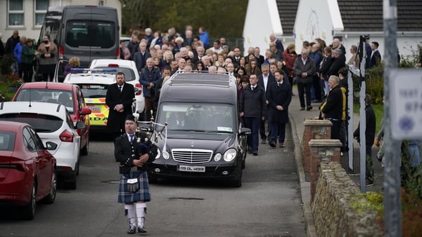 A lone piper led the way as Martin McGill's coffin was brought to St Michael's church