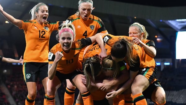 Amber Barrett is mobbed after her historic winning goal