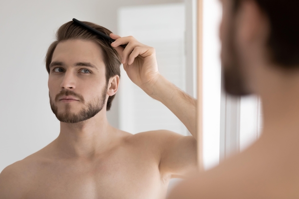 man brushing his hair