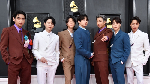 BTS (pictured at the Grammys in Las Vegas in April) - Music stars' agency said "the members of BTS are honoured to serve"