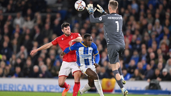 Nottingham Forest goalkeeper Dean Henderson (R) beats Brighton's Danny Welbeck (C) to the ball