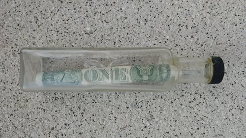 The bottle, containing a $1 note, had been thrown into the sea in 2019