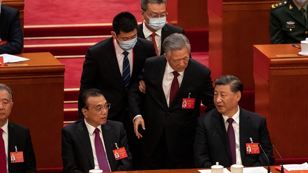 Hu Jintao spoke briefly with Xi Jinping as he was led out