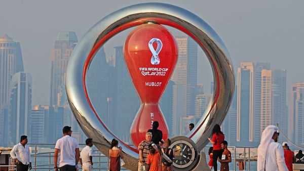 People walk past a World Cup countdown clock in the Qatari capital Doha