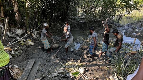 People prepare by collecting mud at the remote southern coastal area of Patharghata in Barguna district