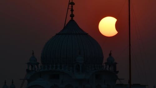 The moon partially obscures the sun during a partial solar eclipse visible from Patna in India