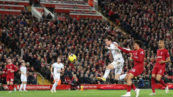 Brenden Aaronson of Leeds United shoots while under pressure from Trent Alexander-Arnold