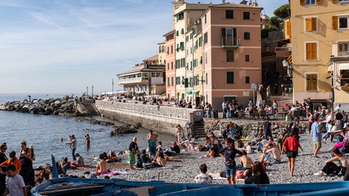 People enjoying the warm weather yesterday in the fisherman village of Boccadesse, near Genova, Italy