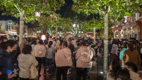 Tourists queue up to leave Shanghai Disney Resort after presenting negative Covid-19 tests