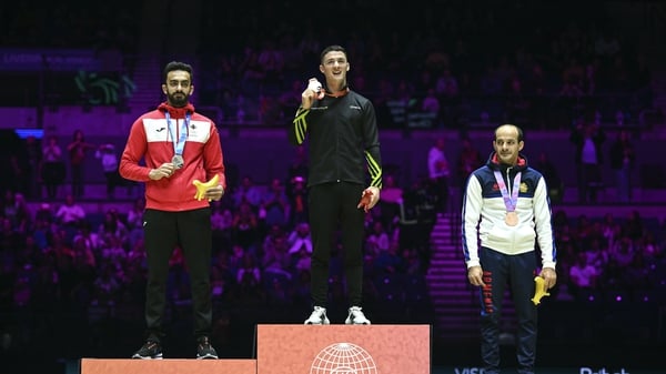 Rhys McClenaghan receives hos gold medal with left, Ahmad Abu Al Soud of Jordan, silver, and Harutyun Merdinyan of Armenia, bronze