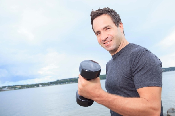Man doing bicep curls outdoors