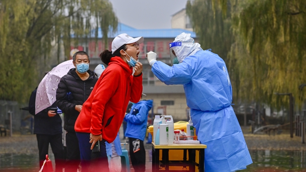 A medical worker carries out Covid tests on residents at a residential community in Hohhot, Inner Mongolia, China